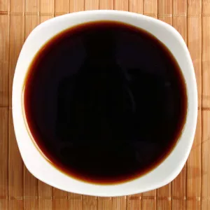 A bowl of soy sauce.